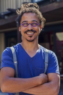 Smiling mixed race man wearing suspenders