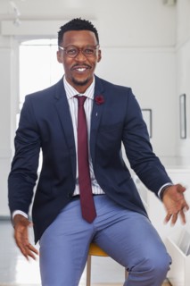 Black man gesturing in gallery