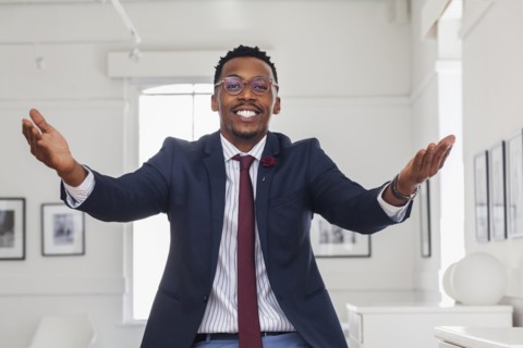 Black man gesturing in gallery