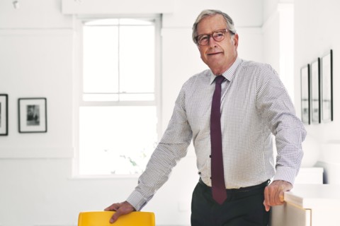 Smiling Caucasian businessman leaning on chair