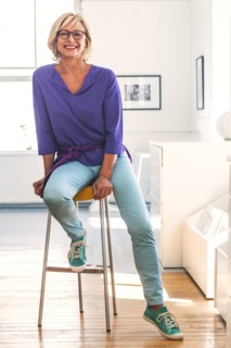 Smiling Caucasian woman sitting on stool