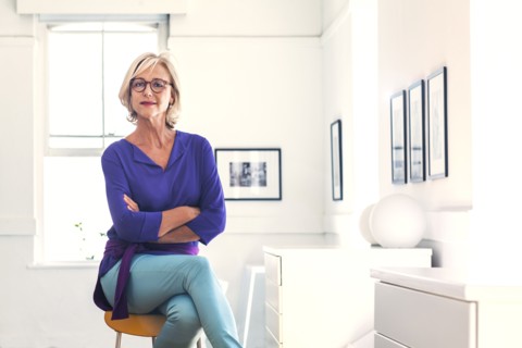 Confident Caucasian woman sitting on stool
