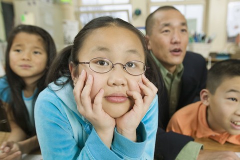 Asian children and father in classroom