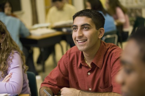 Asian student listening to teacher in classroom