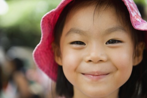 Asian girl in sunhat smiling