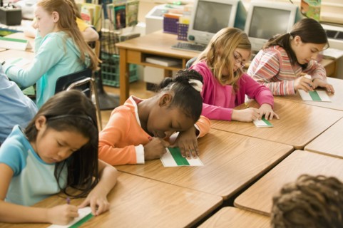 School girls making name cards