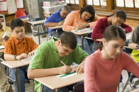 Students making name cards in classroom