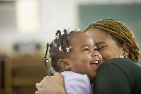 African woman hugging daughter