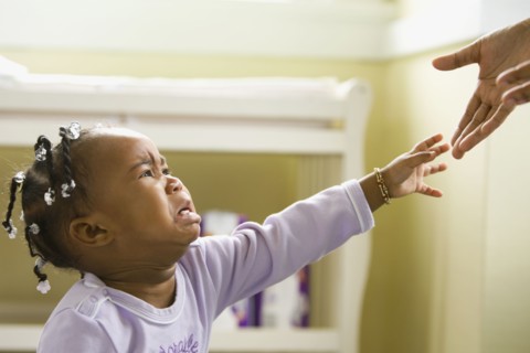 African girl crying and reaching upward