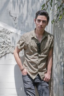 Mixed race teenage boy leaning against wall