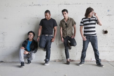 Teenage boys leaning against wall
