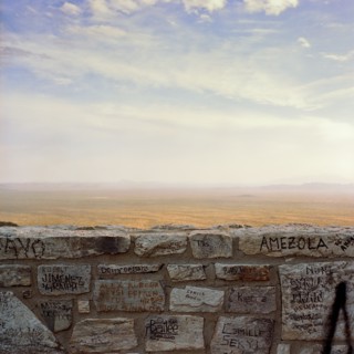 Graffiti on wall with desert in background