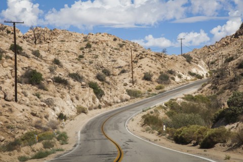 Empty road on rural desert hillside