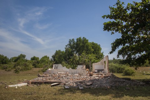 Rubble of demolished building in rural field