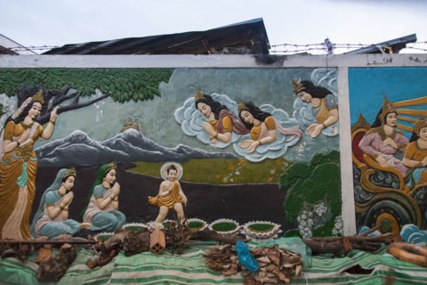 Mural of Buddhist figures painted on wall