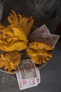 Close up of fruit and money in shrine