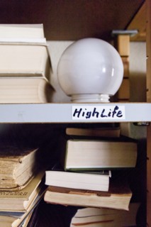 Close up of light bulb on shelf with books