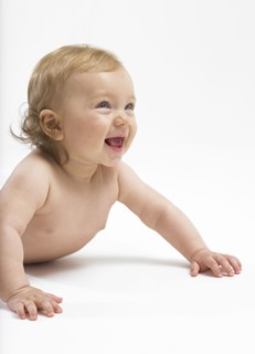 Mixed race baby girl crawling on floor