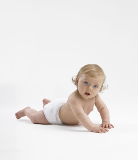 Mixed race baby girl crawling on floor