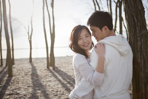 Korean couple hugging outdoors
