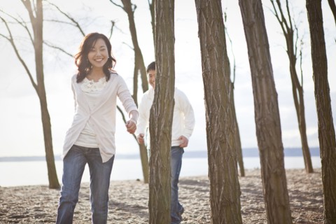 Korean couple walking on beach