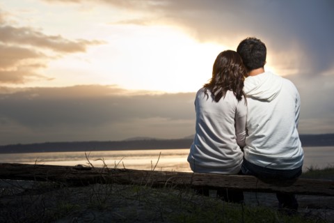 Korean couple enjoying sunset at beach