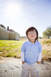 Chinese boy standing with hands in pockets