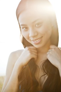 Smiling Chinese woman holding her hair