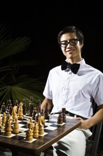 Mixed race geek playing chess