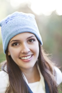 Mixed race woman in cap outdoors