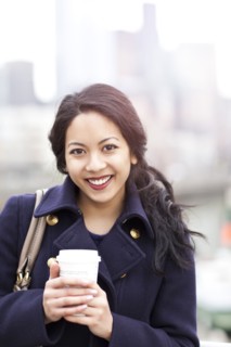 Mixed race woman drinking coffee