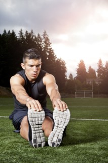 Hispanic man stretching before exercise