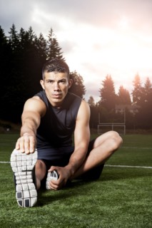 Hispanic man stretching before exercise