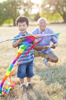 Chinese grandfather and grandson flying kite