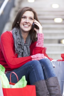 Mixed race woman shopping and talking on cell phone
