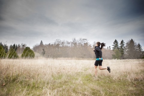 Asian woman jogging in field