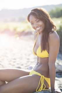 Mixed race woman in bikini on beach