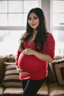 Asian woman holding her pregnant belly