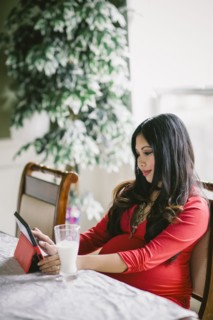 Pregnant Asian woman using digital tablet