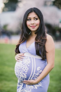 Asian woman holding her pregnant belly