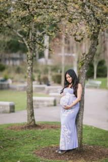 Asian woman holding her pregnant belly
