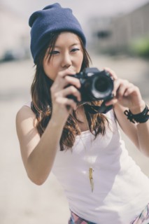 Korean woman taking pictures on city street