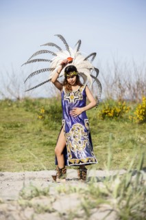 Native American woman in traditional headdress performing ceremony