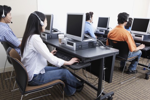 Young computer service technicians with headsets