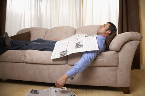 Hispanic man sleeping on sofa