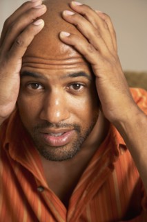 Mixed Race man with hands on head
