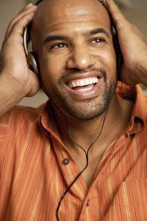 Mixed Race man listening to headphones