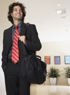Hispanic businessman carrying bag
