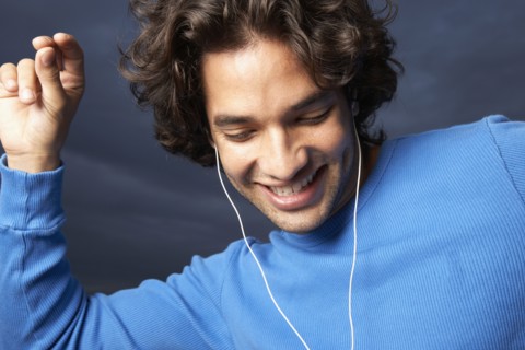 Hispanic man dancing to mp3 player