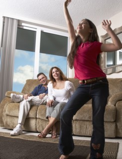 Hispanic girl dancing for parents